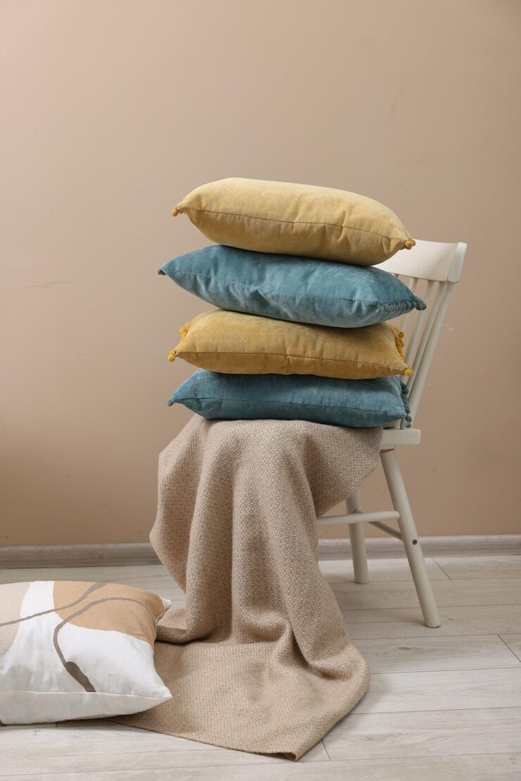 Soft Pillows Warm Blanket Near Beige Wall Indoors by Orient Uniforms for customers in Dubai, Abu Dhabi, Sharjah, Ajman and across the UAE